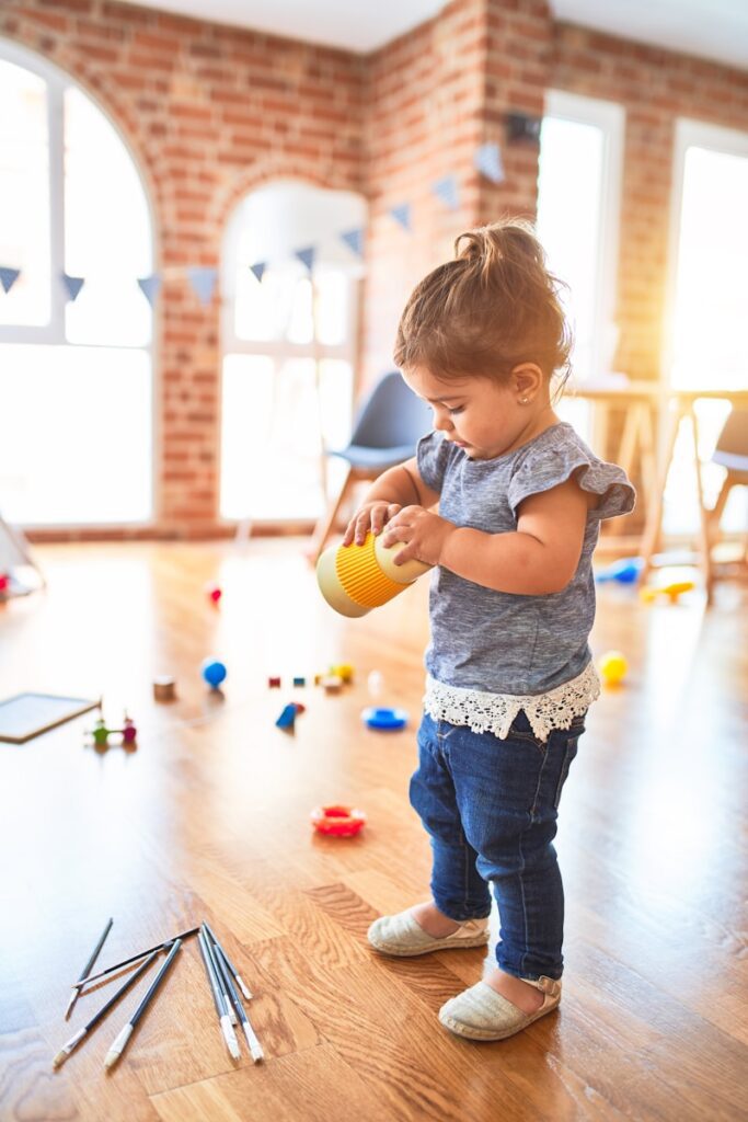 Photo by krakenimages girl in blue denim dungaree pants holding blue and white polka dot handbag